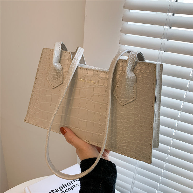 Modern women’s shoulder bag in square design with clean lines