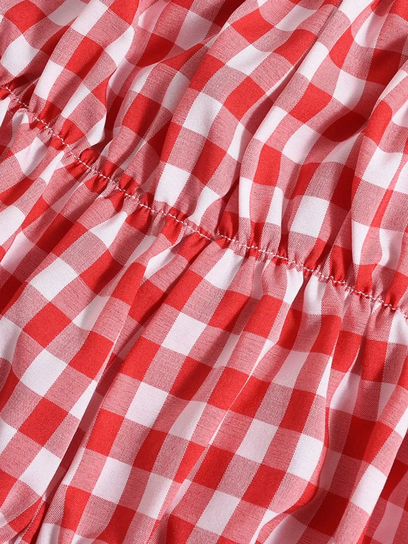 Close-up of red and white plaid fabric with ruched detail, perfect for a halter neck cami set.
