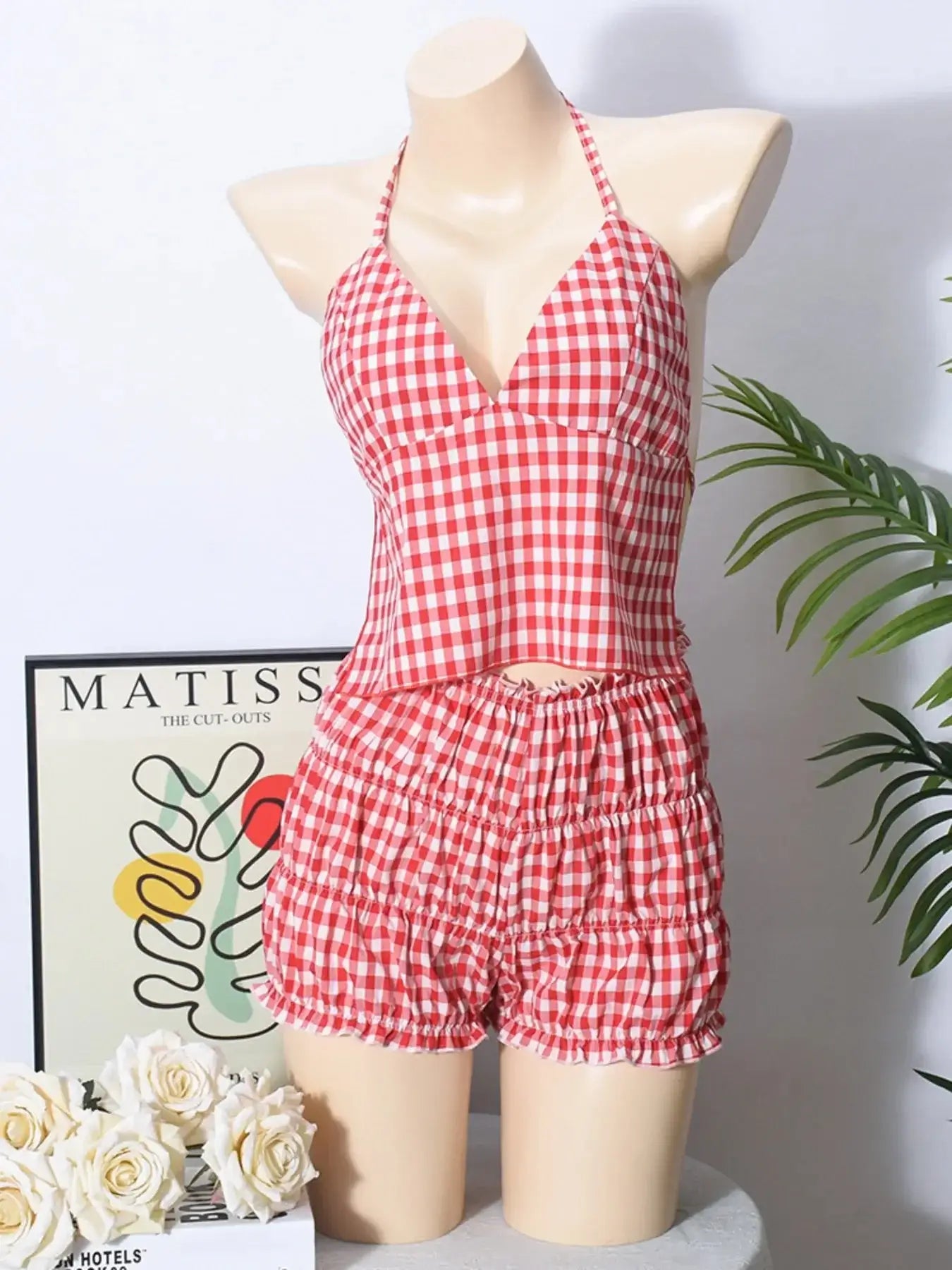 Plaid halter neck cami and shorts set on mannequin, featuring a tied design and ruched shorts.