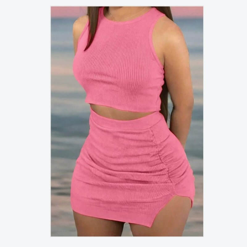 Ladies' ribbed crop top and bodycon skirt set in pink, made of polyester with a stylish design for modern outfits.