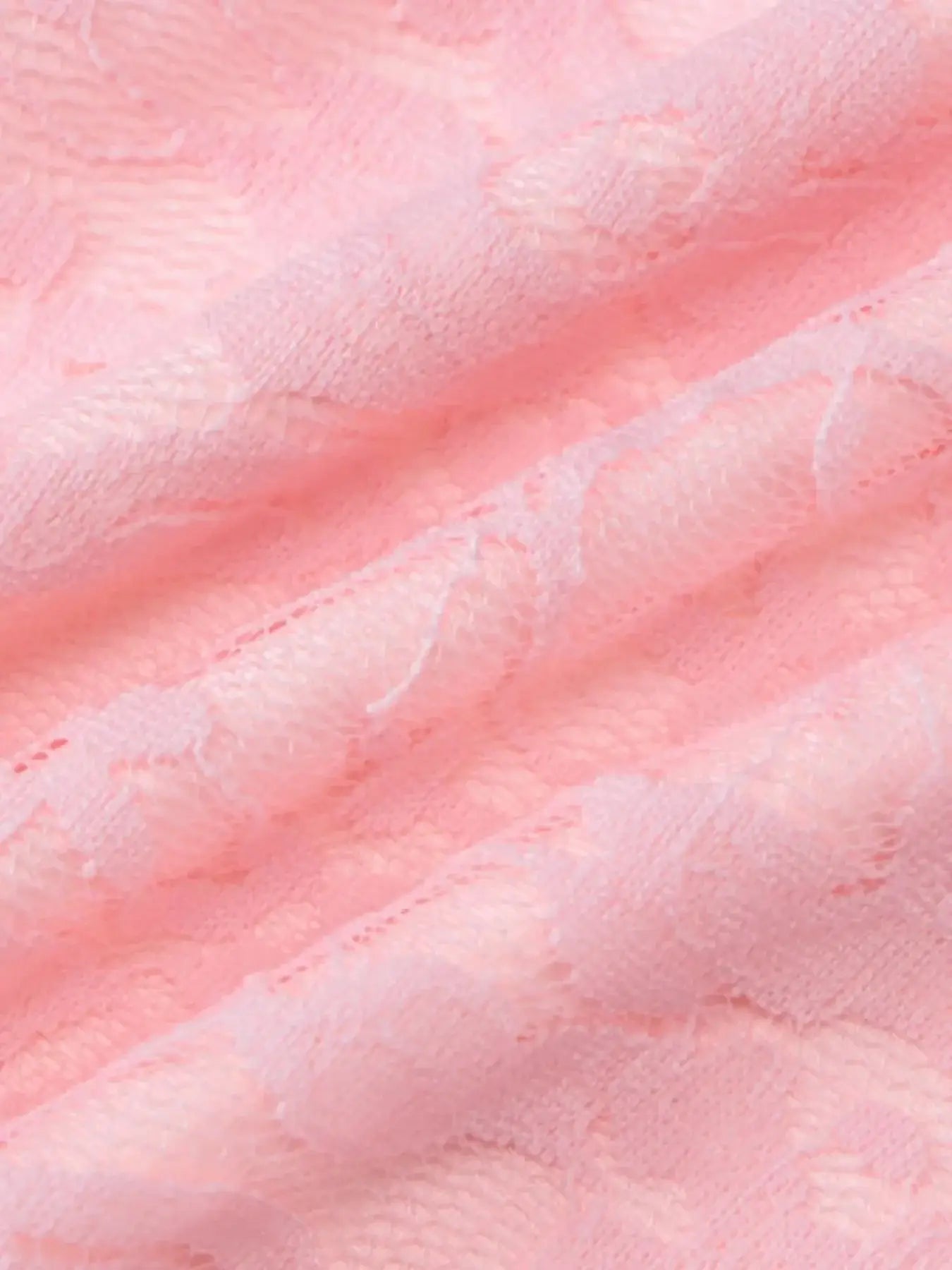 Close-up of soft, sheer pink lace fabric, showcasing delicate floral patterns.