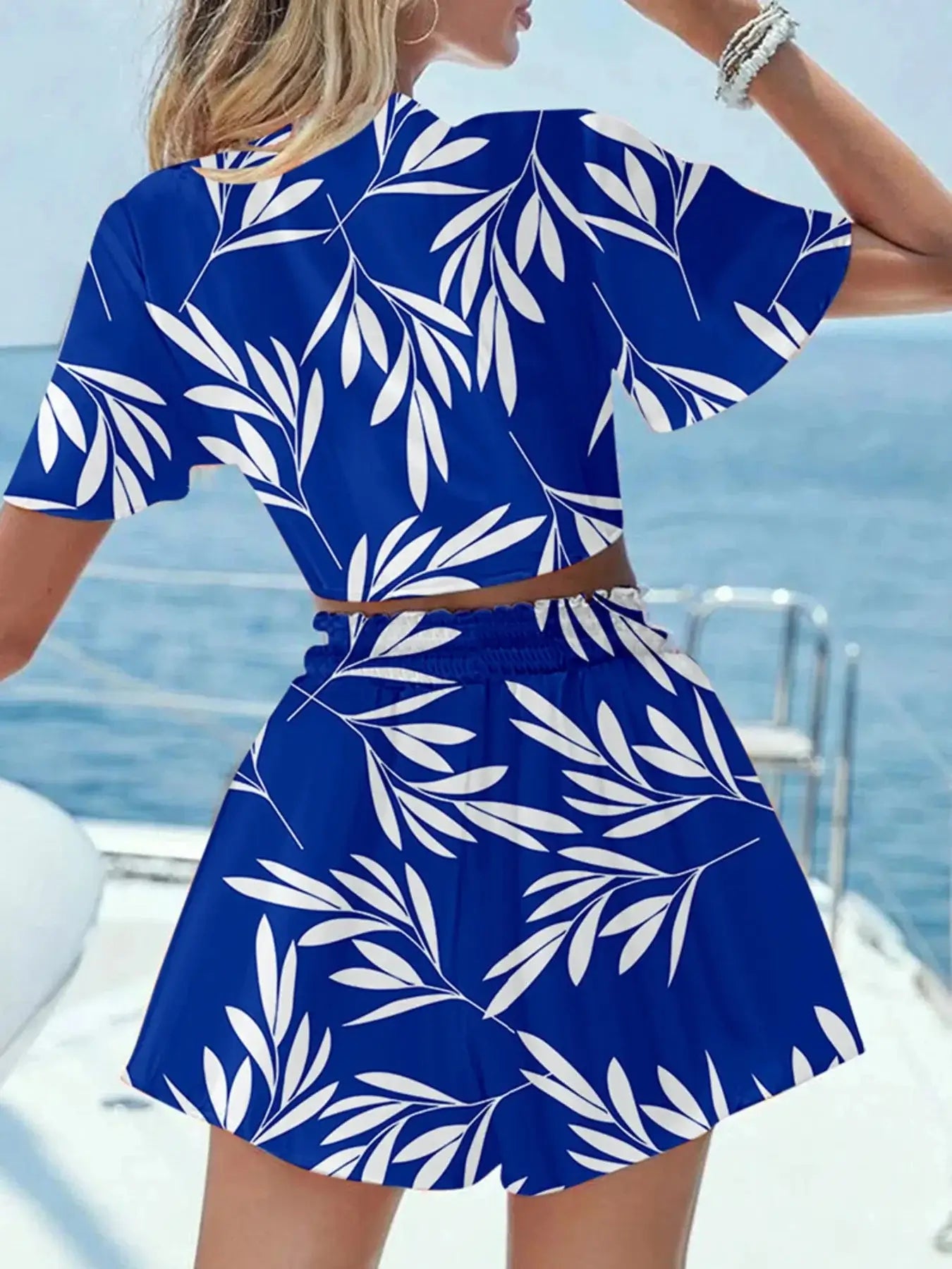 Blue printed tie front top and shorts set with tropical leaf design, perfect for summer outings.