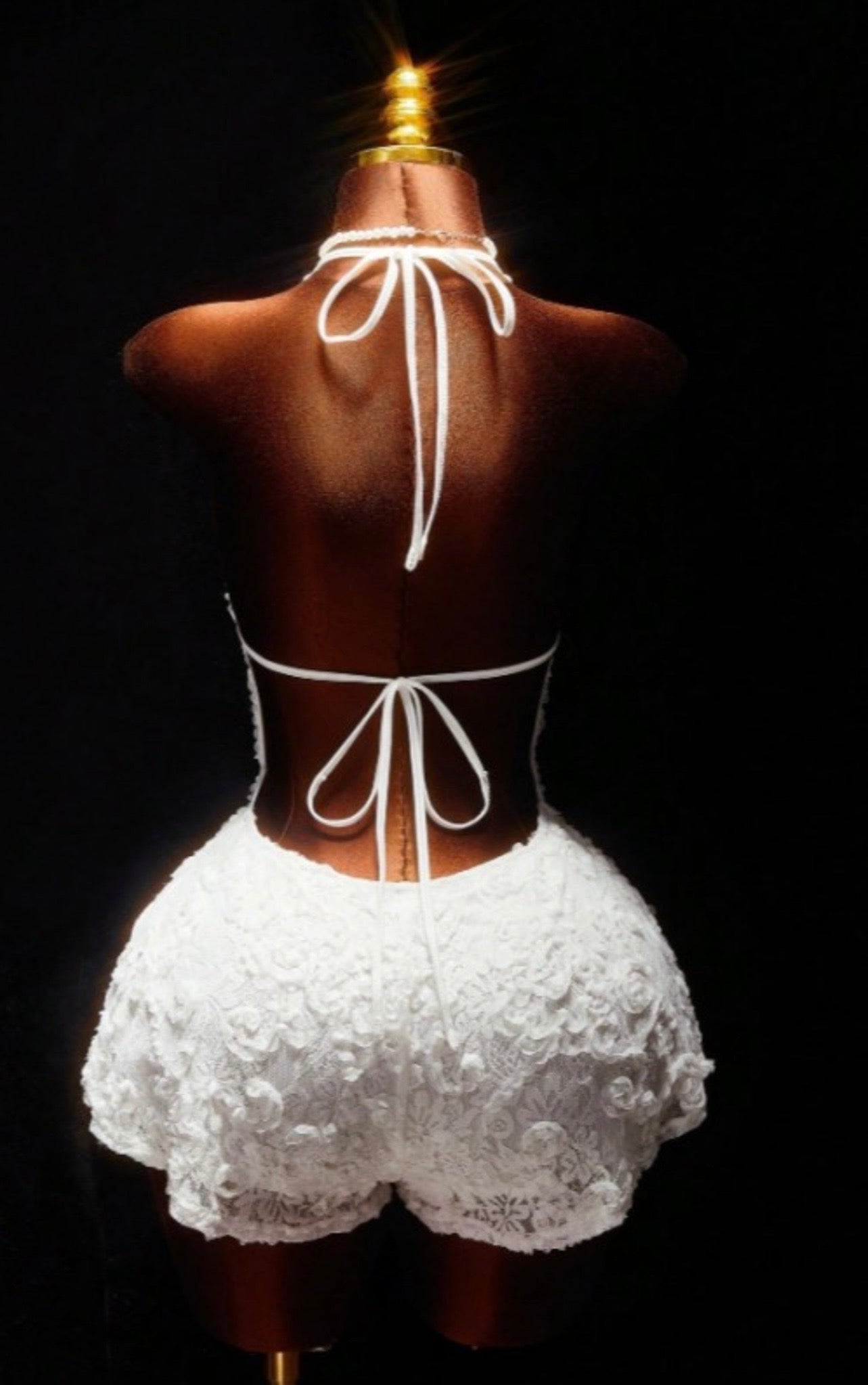 Floral lace halter romper from Sugarz Chique Boutique featuring intricate lace details and a stylish halter neckline.