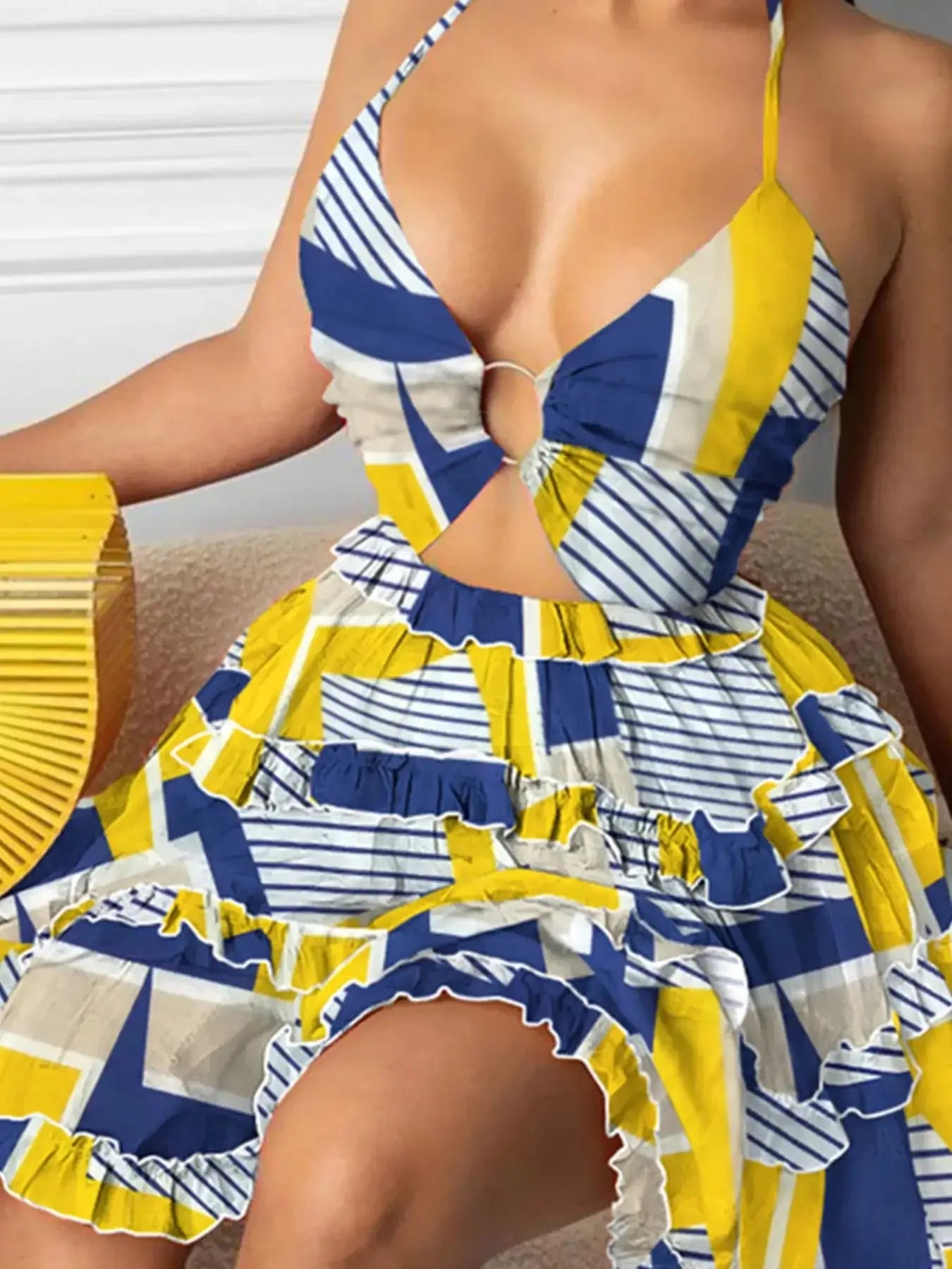 Full size cutout halter neck cami dress in blue and yellow, featuring ruffled tiered design and vibrant geometric patterns.