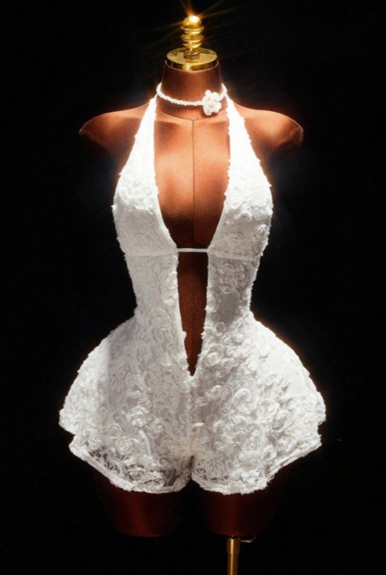 Floral lace halter romper from Sugarz Chique Boutique featuring intricate lace details and a stylish halter neckline.