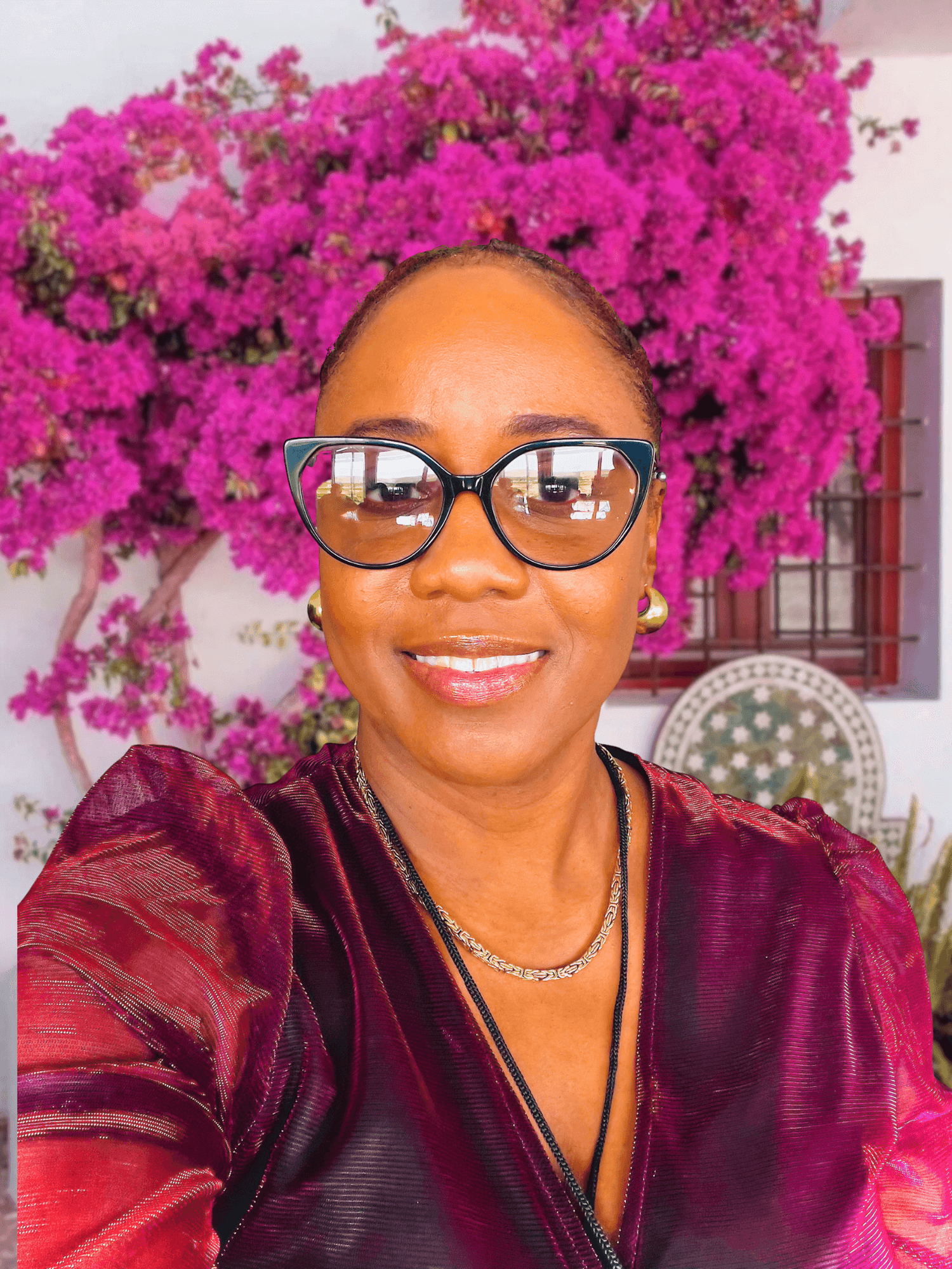 owner of Sugarz Chique boutique with pink floral background