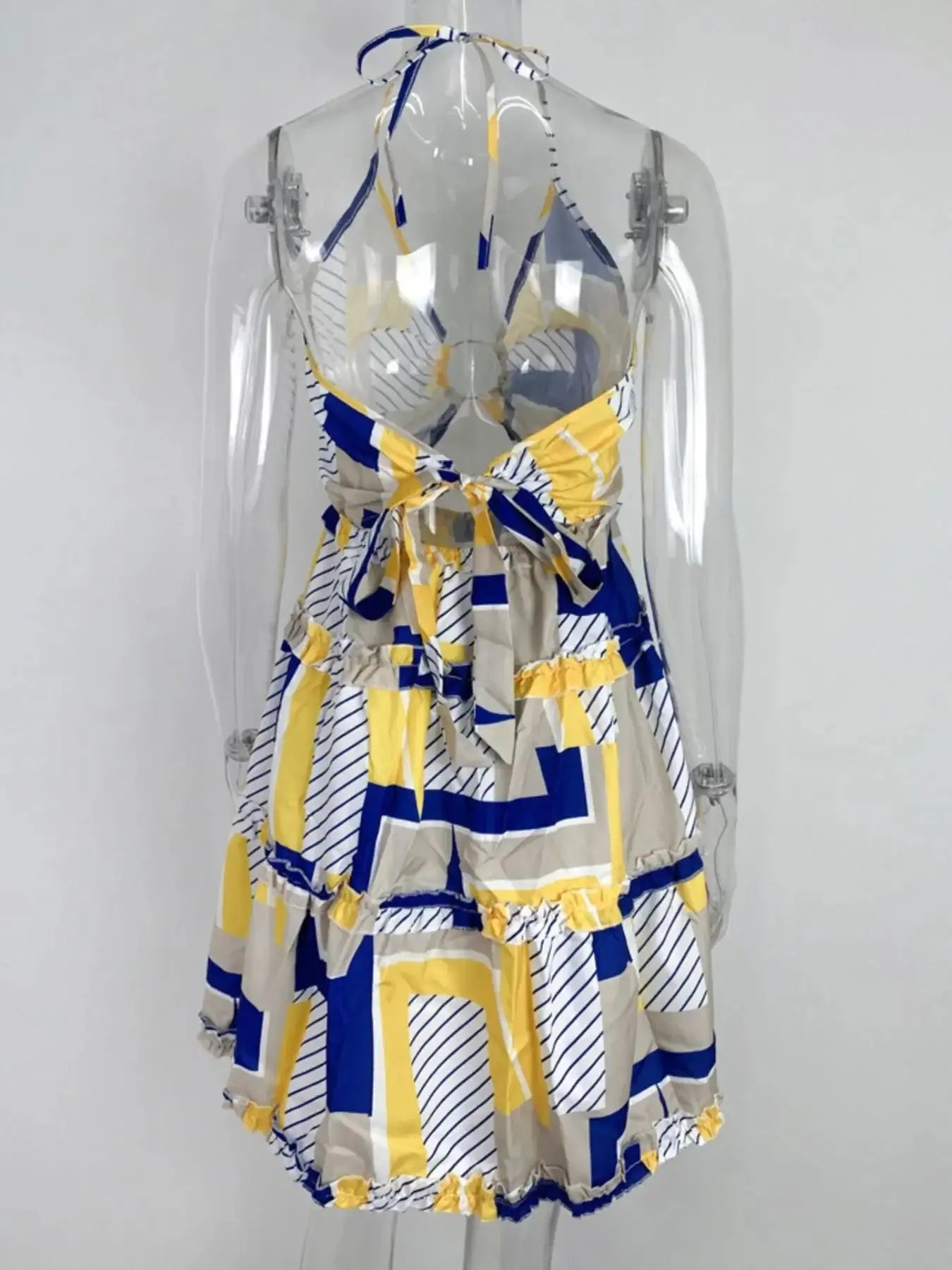 Full size cutout halter neck cami dress in yellow and blue geometric print, featuring ruffled tiered design.