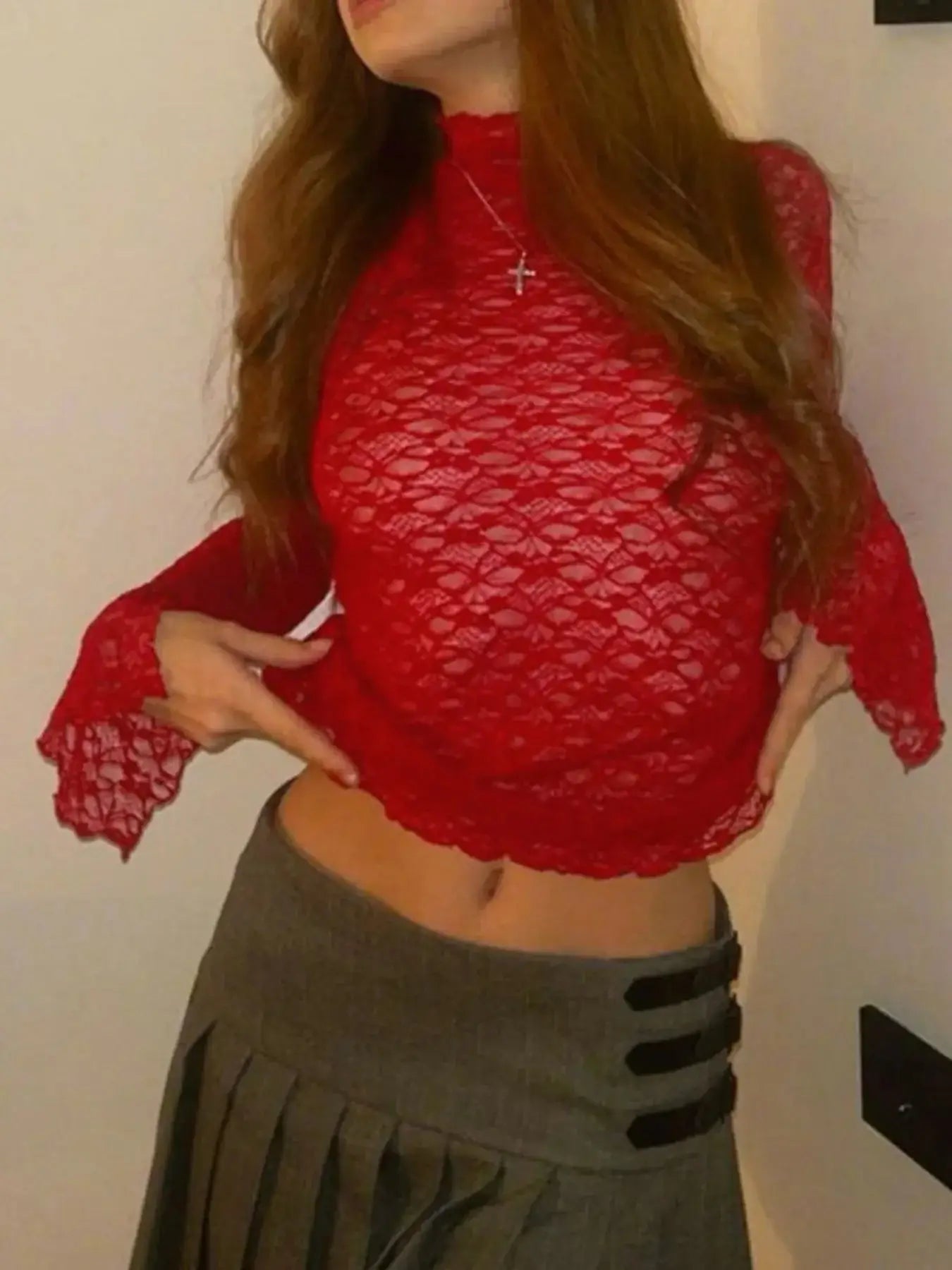 Red mock neck lace long sleeve mesh t-shirt styled with a gray skirt, showcasing a chic and trendy outfit.