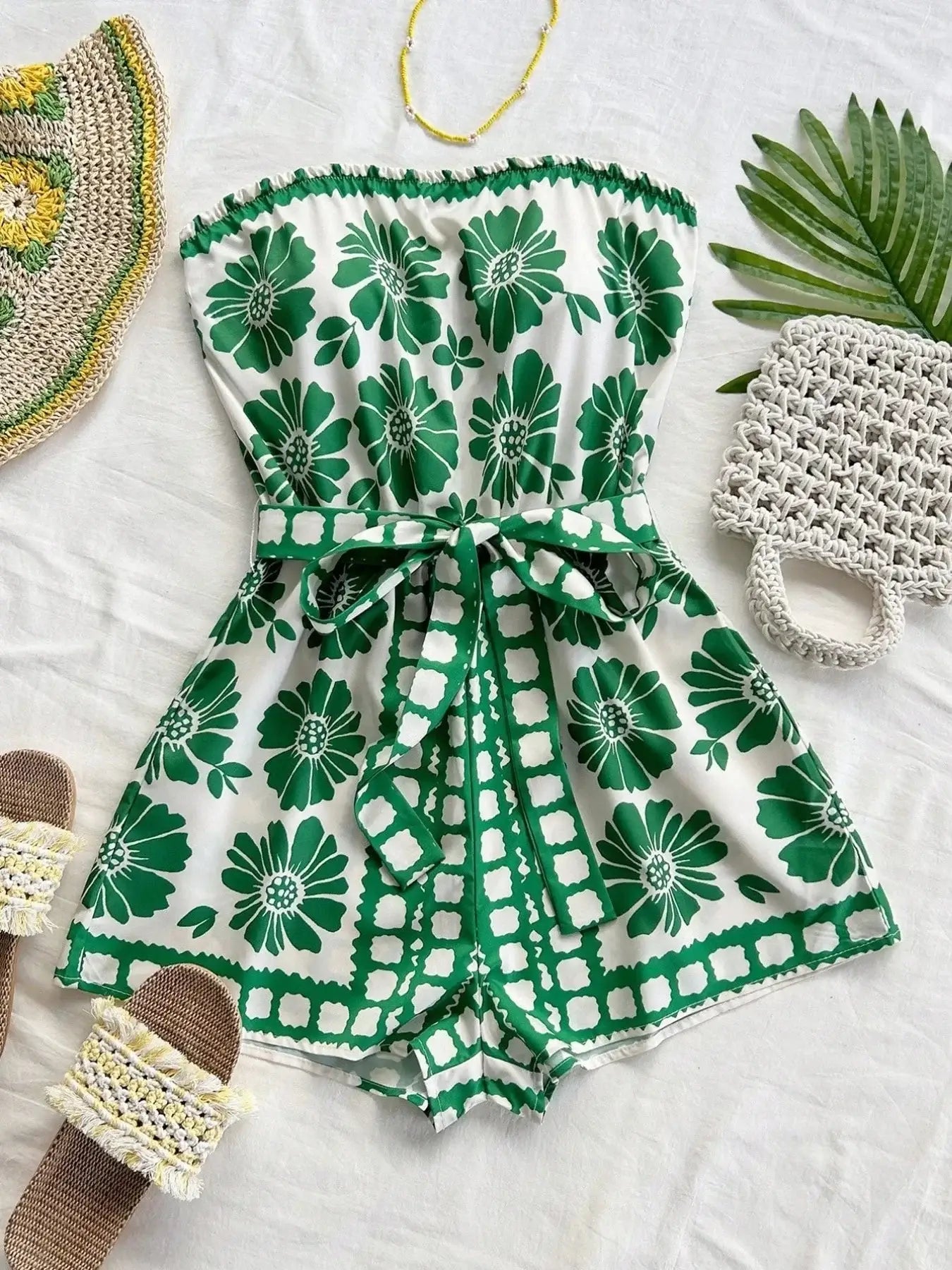 Printed tube tie waist romper in green floral pattern, perfect for summer outings, featuring belted design and easy care fabric.