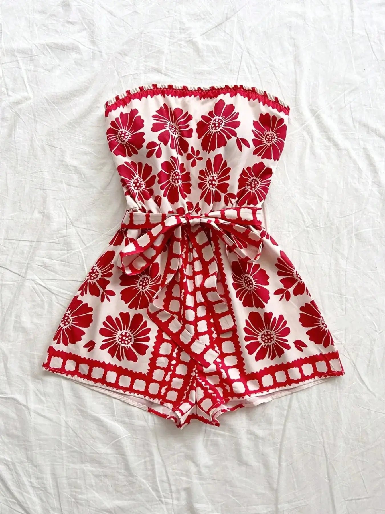 Printed tube tie waist romper in red floral pattern, made of 100% polyester, perfect for summer wear.